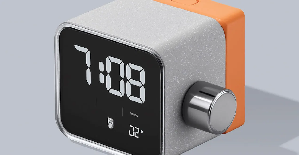 Cube-shaped digital alarm clock with an orange case and a chrome dial